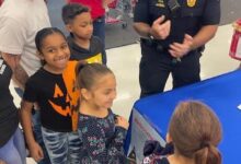 Building toy chests and relationships: Police officers help Missouri City kids at Shop with a Cop