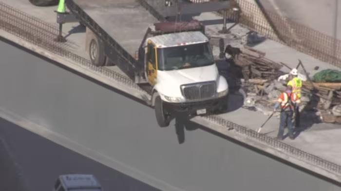 Truck hangs precariously off FM 1093 flyover, driver walks away